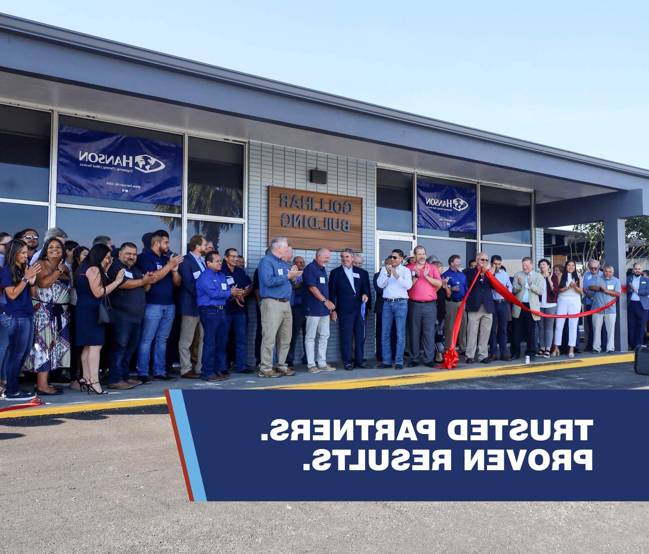 a photo of a large group of people having a ribbon cutting at Hanson's Corpus Christi, Texas office